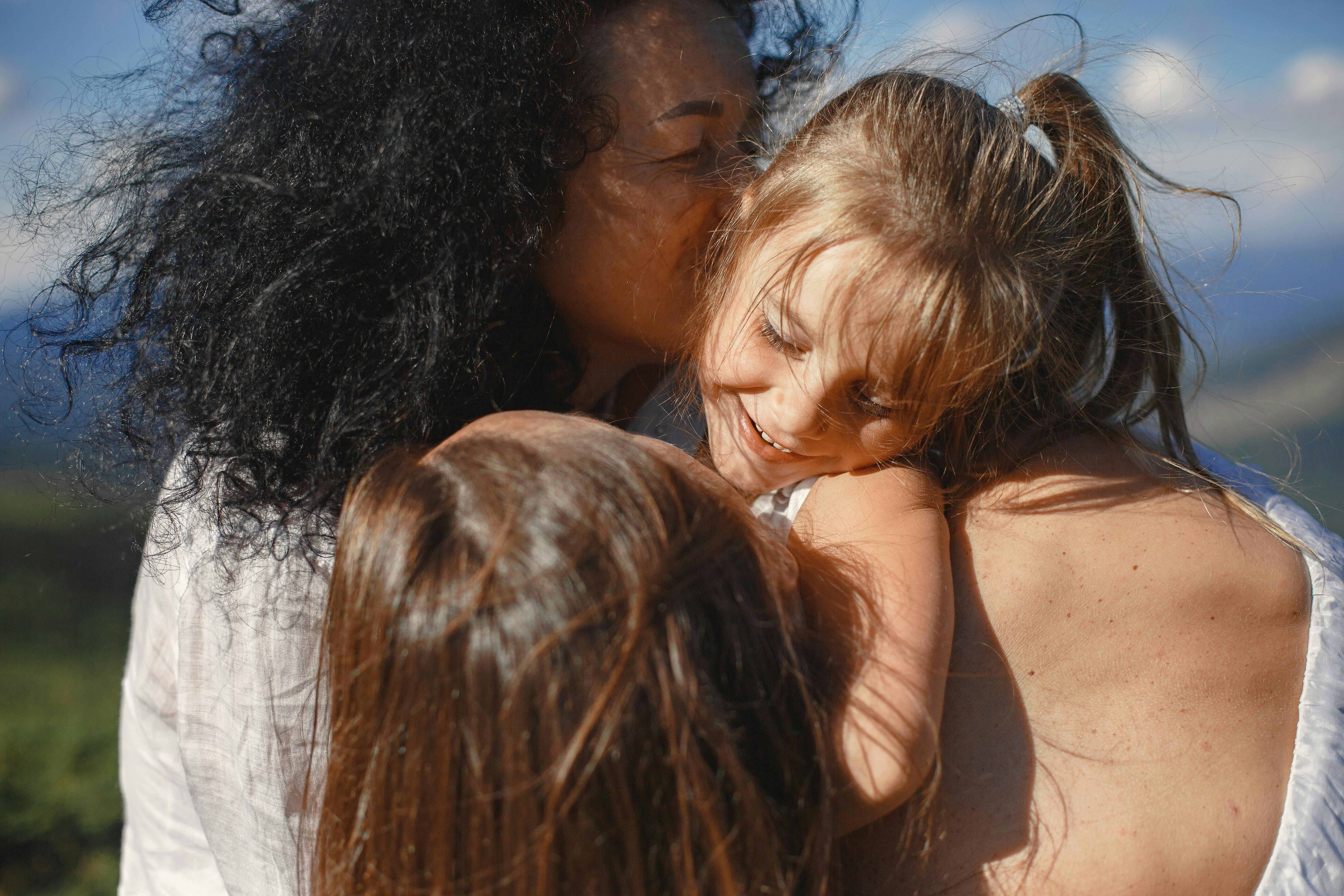 family members huggin in nature